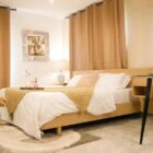 Bed, accent chair and coffe table in a studio apartment at Labone Accra